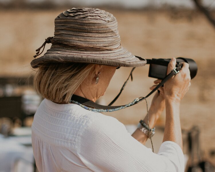 woman taking photograph on safari